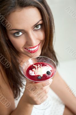 Portrait of an young beautiful woman eating an ice cream in cafe