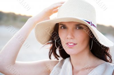 Summer portrait of beautiful woman wearing hat. Vacation at warm