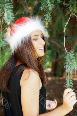 Portrait of a sexy young female smiling in a park and looking at