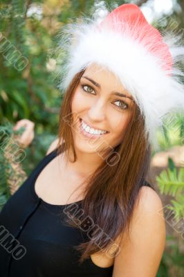 Portrait of a sexy young female smiling in a park and looking at
