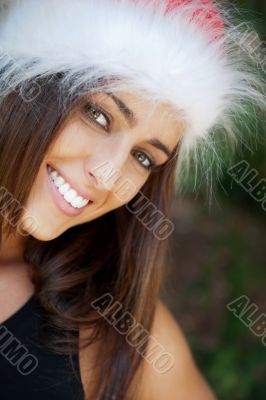 Portrait of a sexy young female smiling in a park and looking at