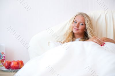 Portrait Of Young Woman Relaxing On Bed