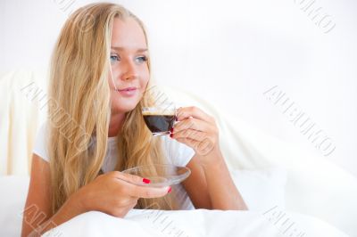 Closeup portrait of a pretty young female having a cup of coffee