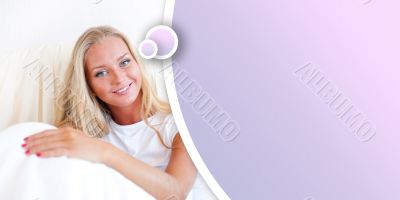 Young blond woman enjoying a sunny morning in bed