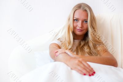 Portrait Of Young Woman Relaxing On Bed