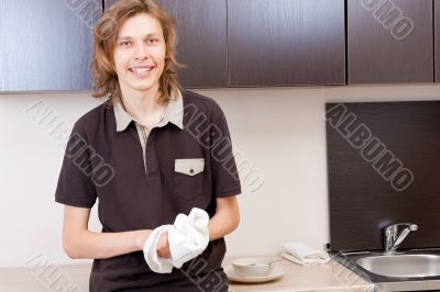 Happy young man after having a breakfast at home