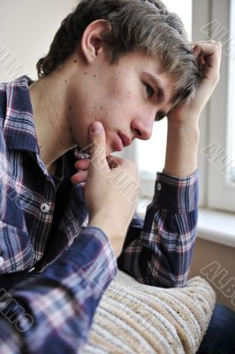 Happy young handsome man at home