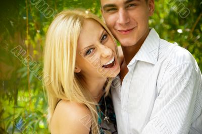 An attractive young woman embracing her handsome boyfiend