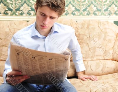 Closeup portrait of young man with newspaper 