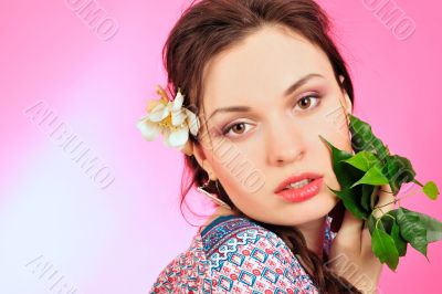 Portrait of a beautiful young girl in Asian clothing, holding a 