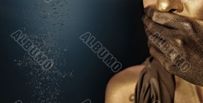 Portrait of young sexy woman in golden paint 