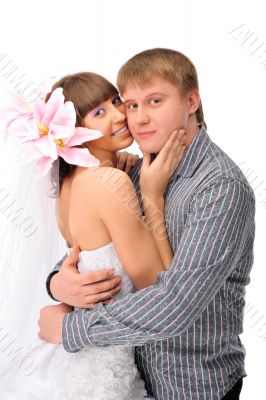 Closeup portrait of young caucasian bride and groom against whit