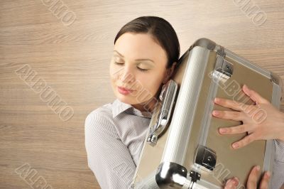 Portrait of a beautiful young businesswoman holding a suitcase l