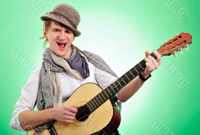 Closeup portrait of cute caucasian man playing the guitar over g