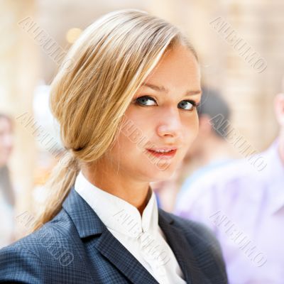 Portrait of a cute business woman with colleagues at the backgro