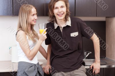 Playful young couple in their kitchen.