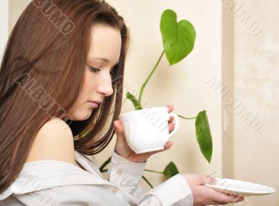 Young woman sitting at the balcony