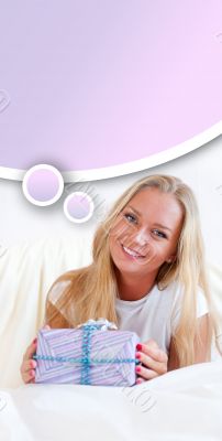 Bedroom surprise present - young happy woman in bedroom