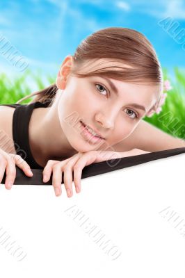 Young woman holding blank board
