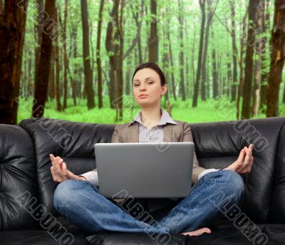 Portrait of young business woman sitting with a laptop on comfor