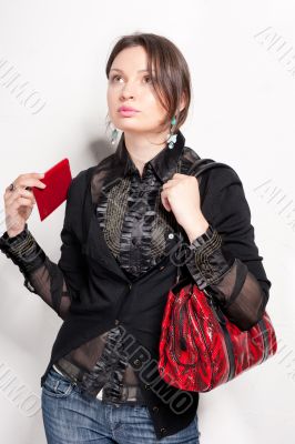 Portrait of a bright beautiful young woman with fashion  handbag