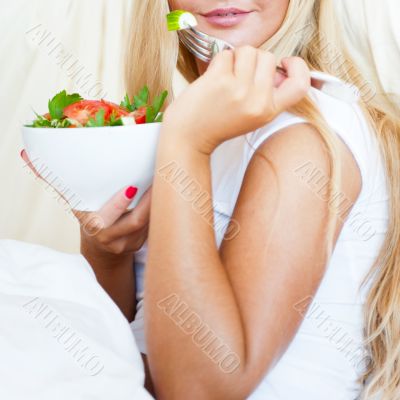 Closeup portrait of a beautiful slender girl eating healthy food