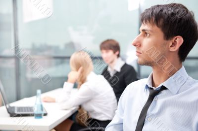 Closeup portrait of a smart young businessman smiling and his co