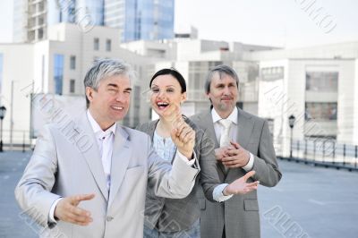 Portrait of three business people outside.