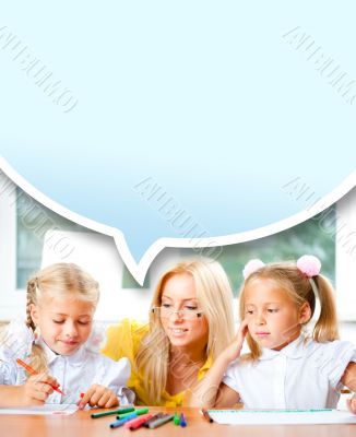 Young pretty teacher helping to her students to make exercise in
