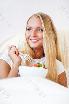 Closeup portrait of a beautiful slender girl eating healthy food