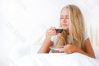 Closeup portrait of a pretty young female having a cup of coffee