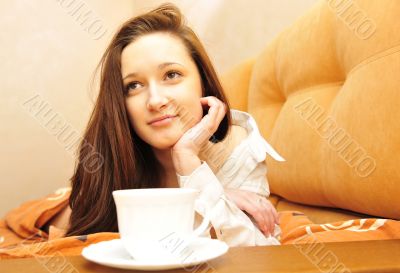 Closeup portrait of young pretty girl laying on her bed