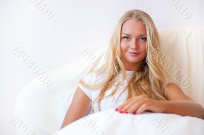 Portrait Of Young Woman Relaxing On Bed