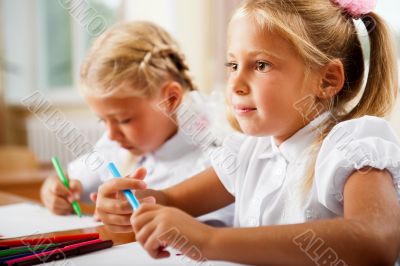 Little girls drawing pictures and writing letters to Santa Claus
