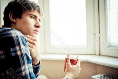 Happy young handsome man at home