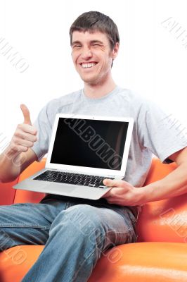 Young man holding his laptop