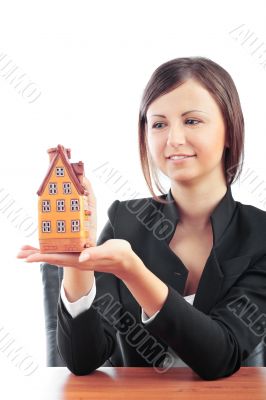 Portrait of young handsome woman holding car in her arms