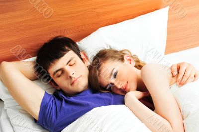 Young man and woman in bed. Couple.