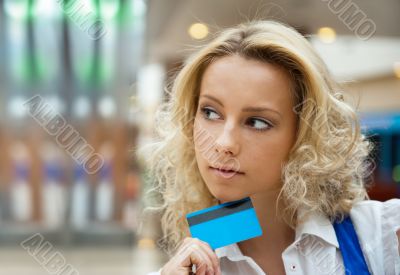 Beautiful shopping woman holding a credit card