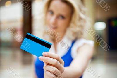 Photo of young joyful woman with shopping bags inside mall 