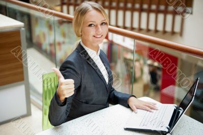 Portrait of a pretty businesswoman sitting at cafe with a laptop