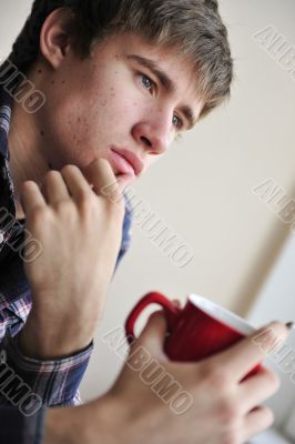 Happy young handsome man at home