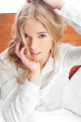 Portrait of young woman laying in bed