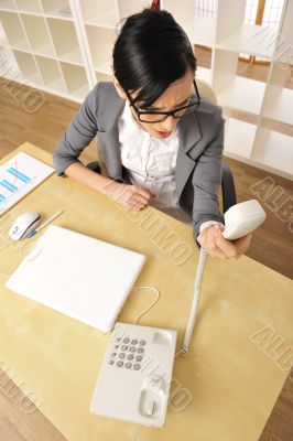 Portrait of a beautiful young businesswoman on the phone and not