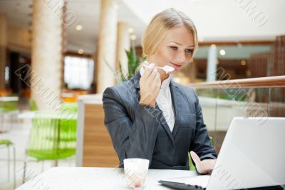 Portrait of a pretty businesswoman sitting at cafe with a laptop