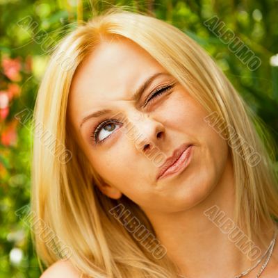 Portrait of a happy young woman posing in a park - Outdoor