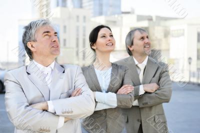 Portrait of three business people outside.