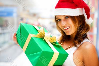 Portrait of young excited pretty woman standing inside shopping 
