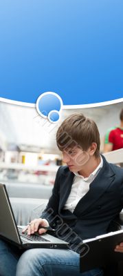 Portrait of handsome young man working with laptop at cafe at bu