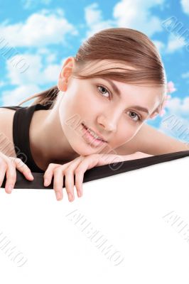 Portrait of a beautiful young woman behind a barrier with the sk